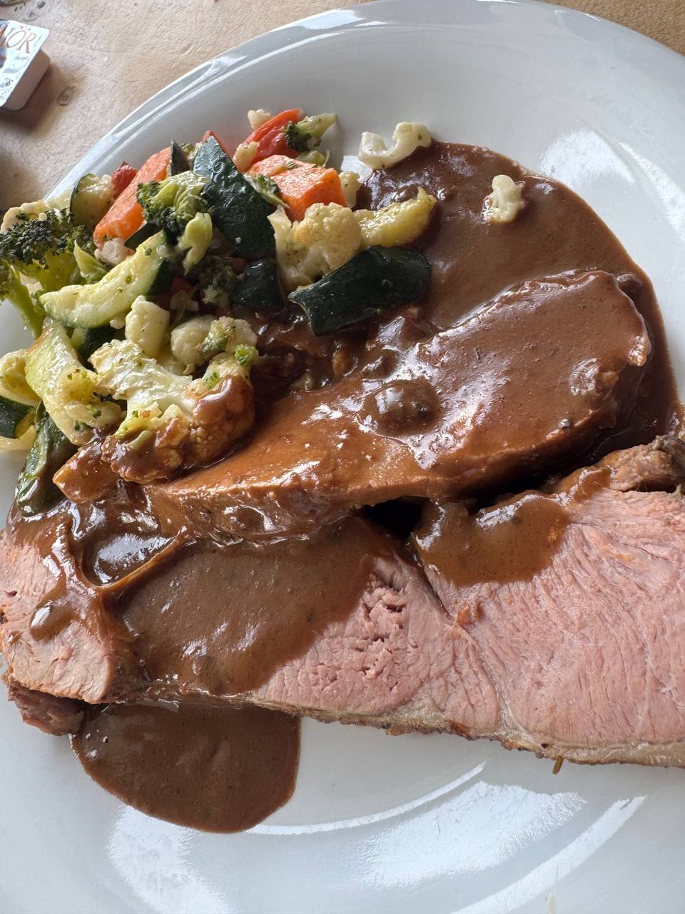 Traditional Icelandic hangikjöt (smoked lamb) with gravy and vegetables served during a Reykjavik Food Tours experience with our agency
