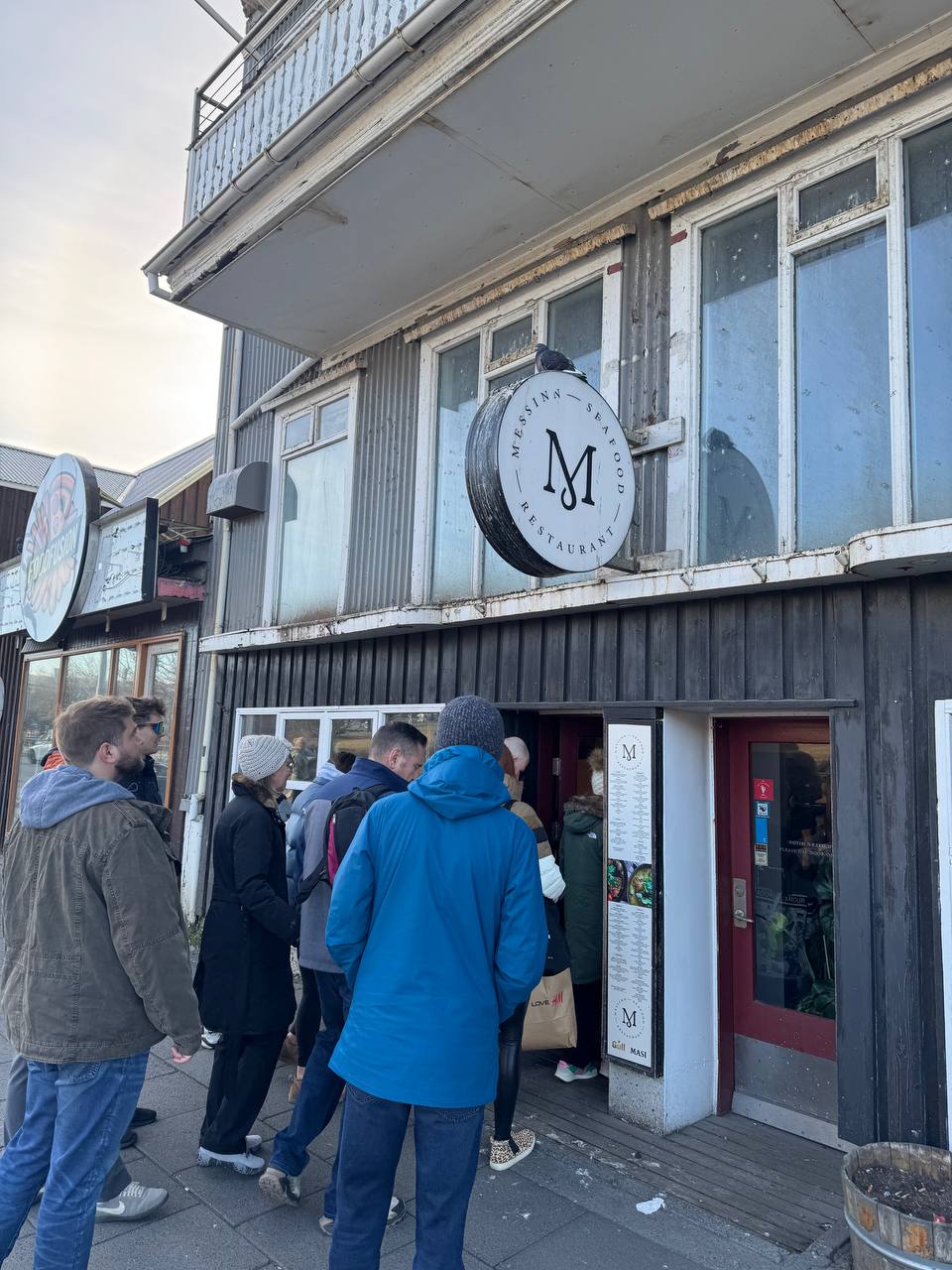 Entrance of Messinn restaurant in Reykjavik with guests joining a guided Reykjavik Food Tours experience with our agency