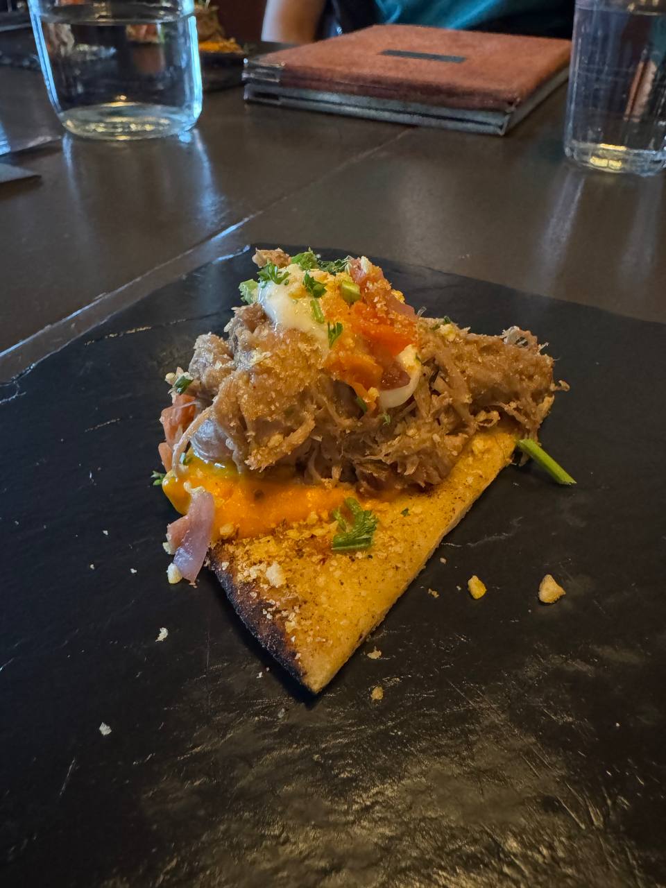 Icelandic slow-cooked lamb served with sauce and crispy base during a Reykjavik Food Tours adventure with our agency